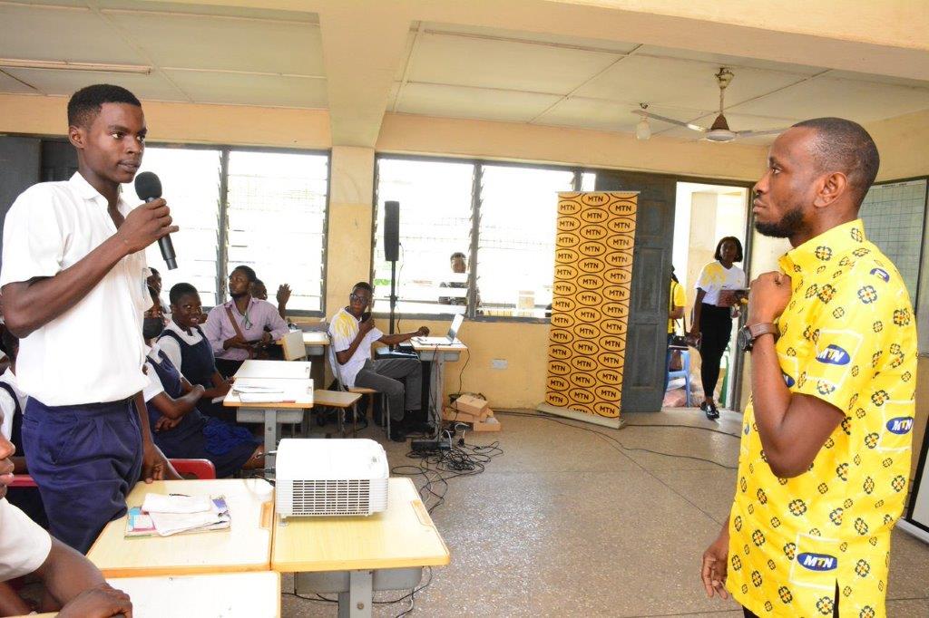 Prince Essandoh, Senior Lead, IT Governance & Compliance interacting with the students at Presby Senior High School, Osu